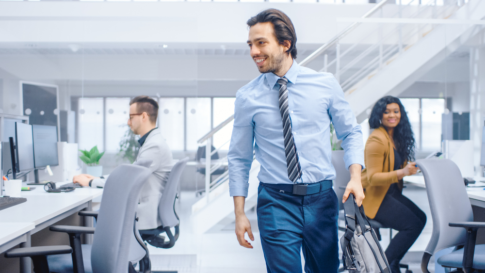 Young,Happy,Businessman,Returns,To,Work,After,Vacation,,Walks,Into